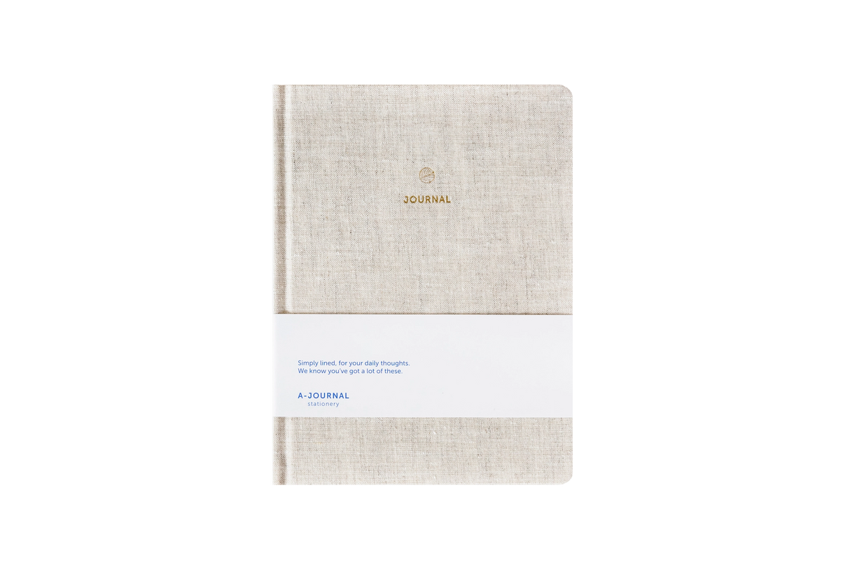 Beige linen hard cover journal on a white background