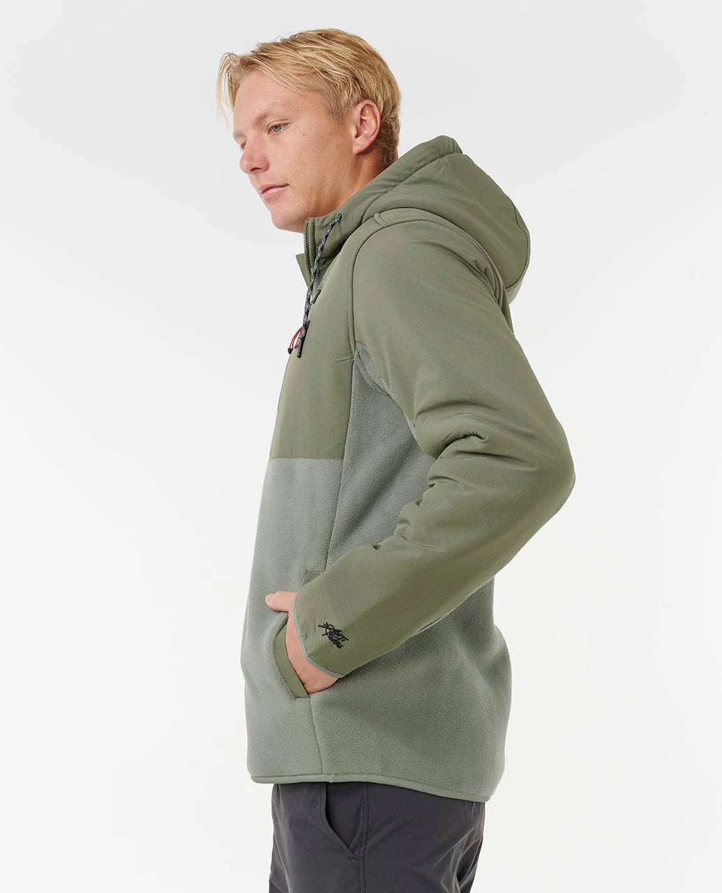 Person wearing a green rip curl anti series fleece jacket on a white background