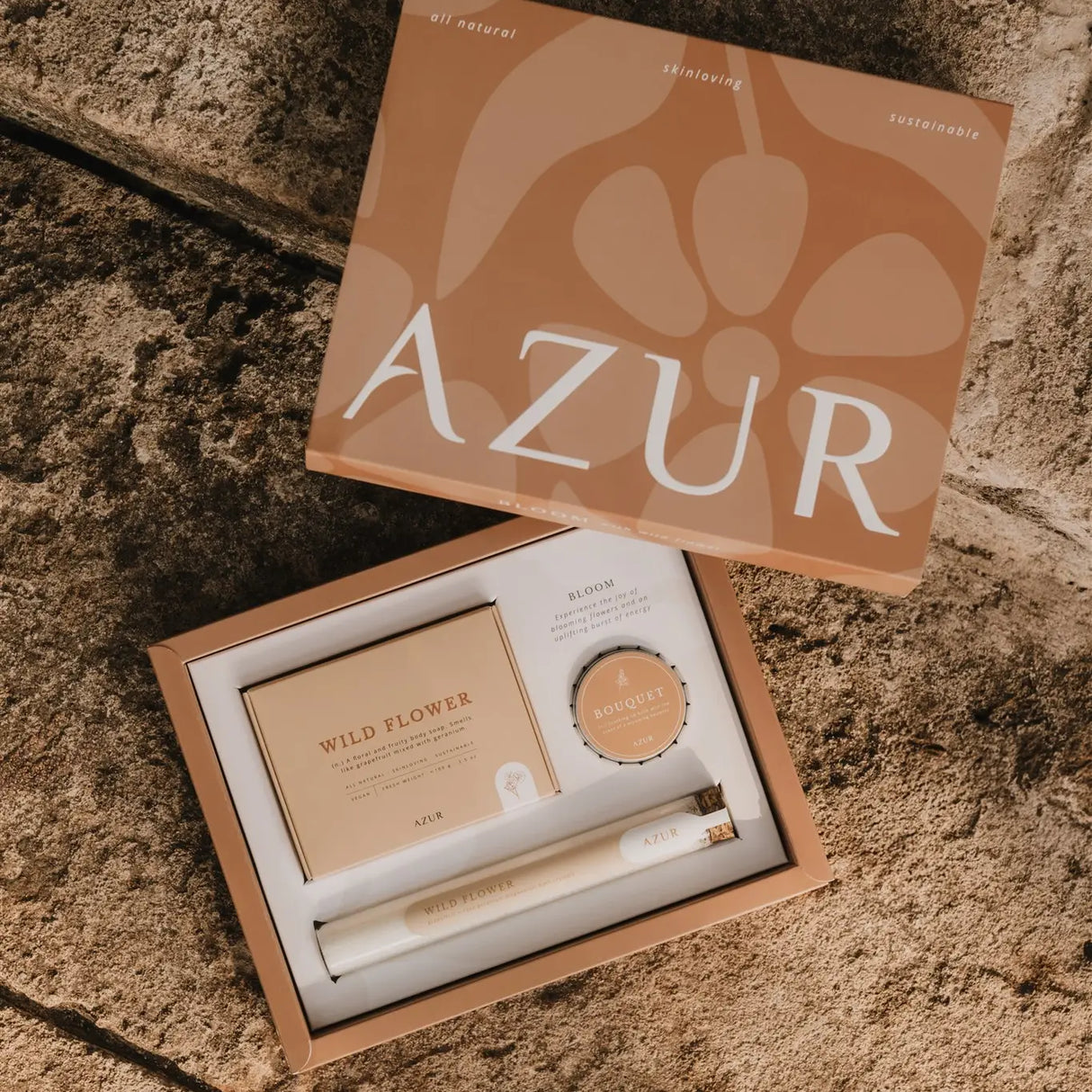 Cosmetic set with 'AZUR' branding on a textured surface