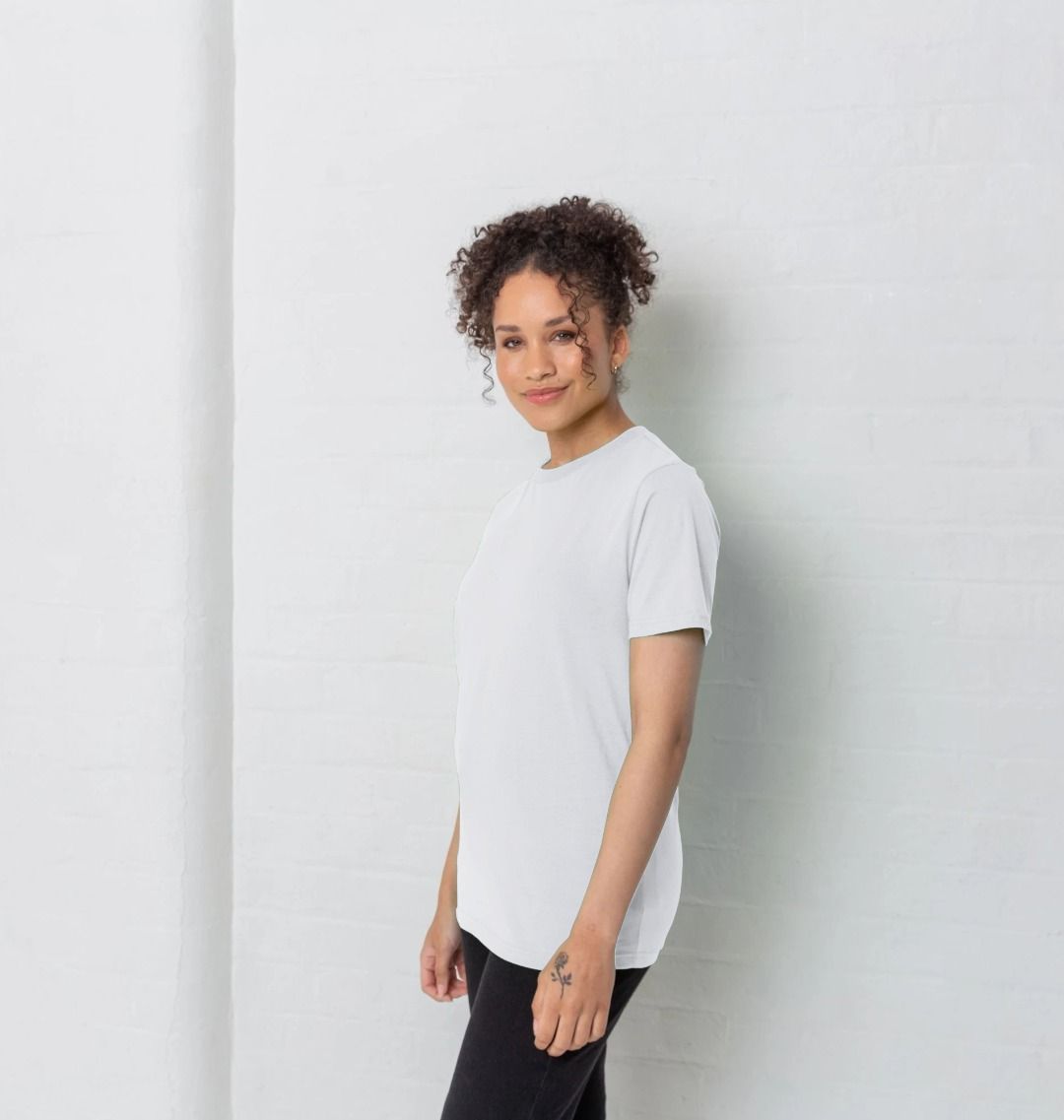 Person wearing a plain white t-shirt against a light gray background