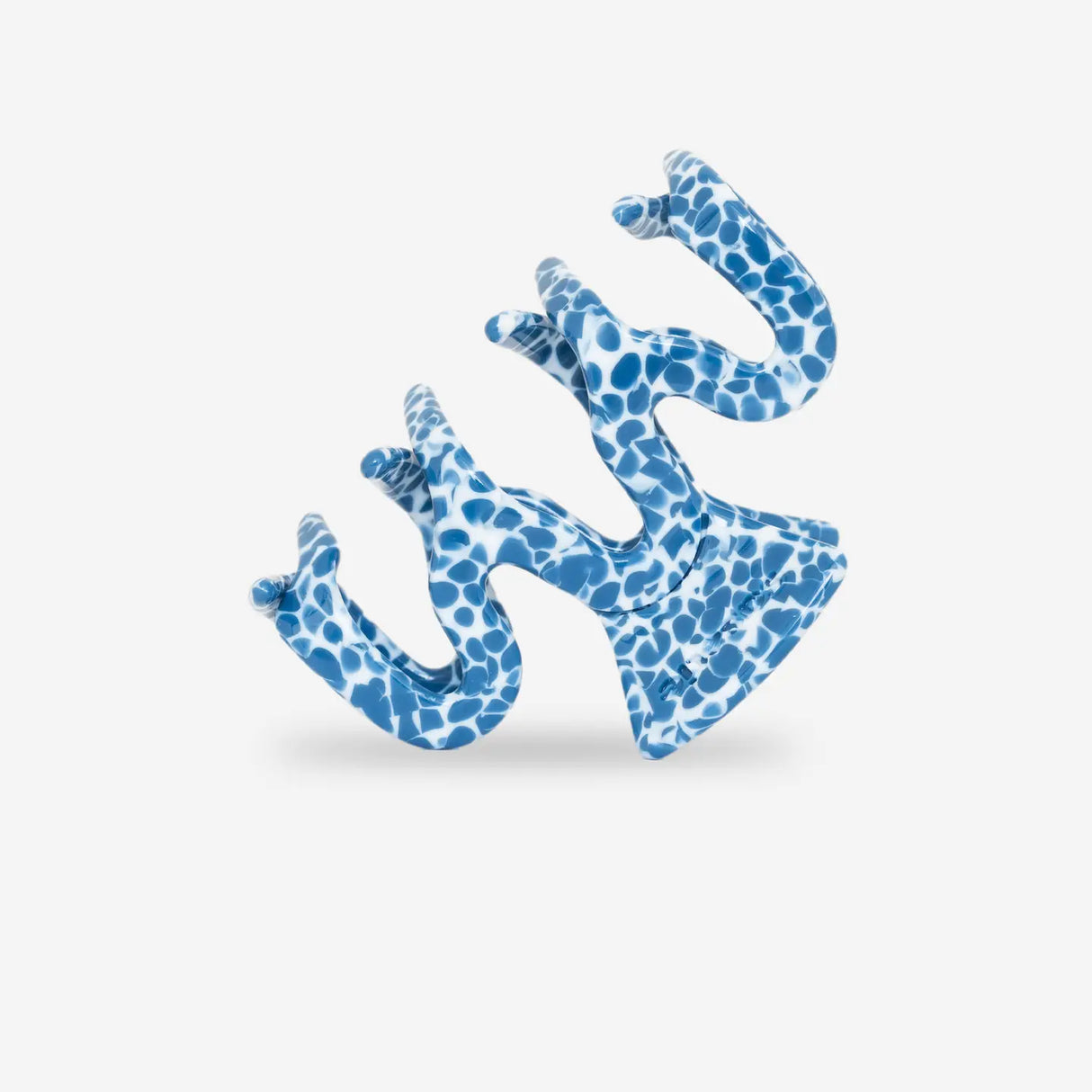 sasstie wave ocean hair clip on it's side in front of a white background