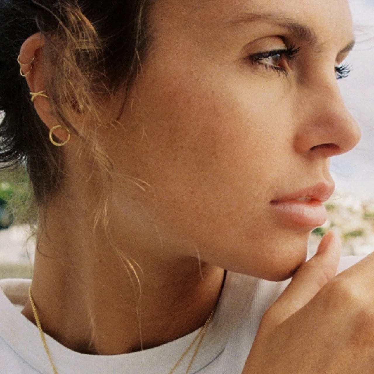 close up of a woman wearing agapee jewellery