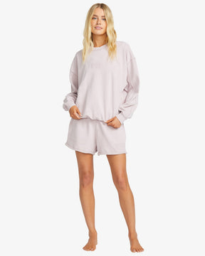 Woman wearing a billabong so typical sweater loungewear set on a white background
