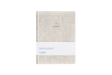 Beige linen hard cover journal on a white background