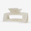 Beige Sasstie hair clip with textured surface on a white background