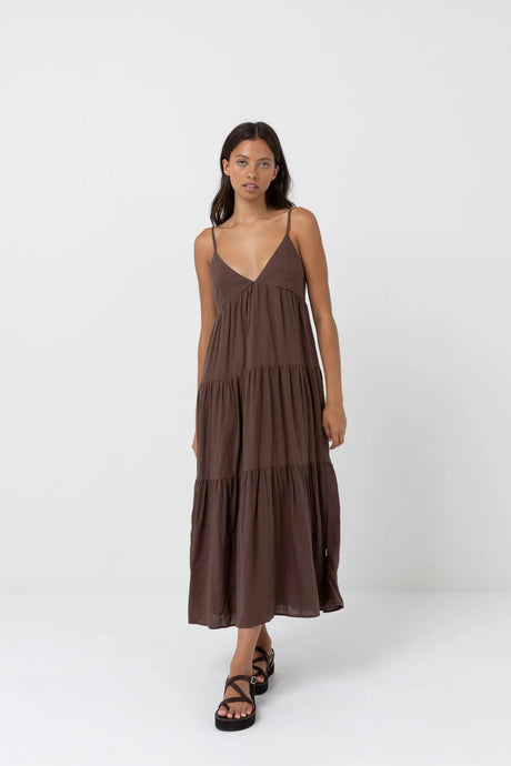 Woman wearing a rhythm chocolate tiered maxi dress on a white background