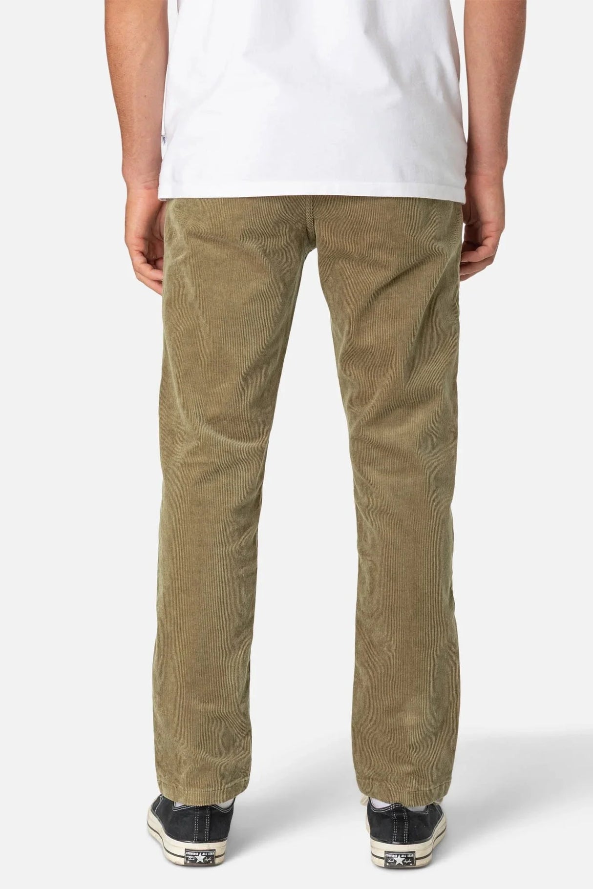 Person wearing khaki Katin corduroy pants on a white background