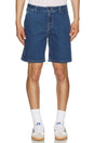 Person wearing dark wash rhythm denim shorts on a white background