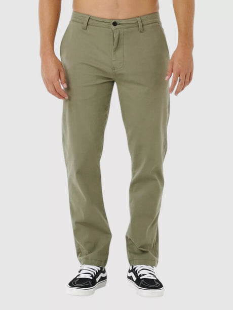 Man wearing rip curl classic surf chino cactus green pants on a white background