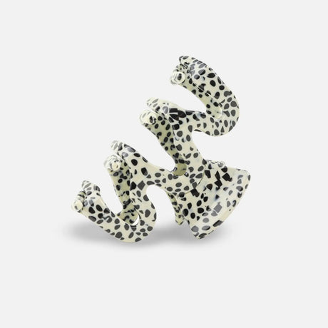 Polka dot sasstie hair clip on a white background